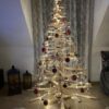 Tall Franky Holzweihnachtsbaum aus Kiefernholz mit einer Höhe von 175 cm, dekoriert mit Lichterketten und bunten Kugeln, ideal als festliche Dekoration für große Räume.